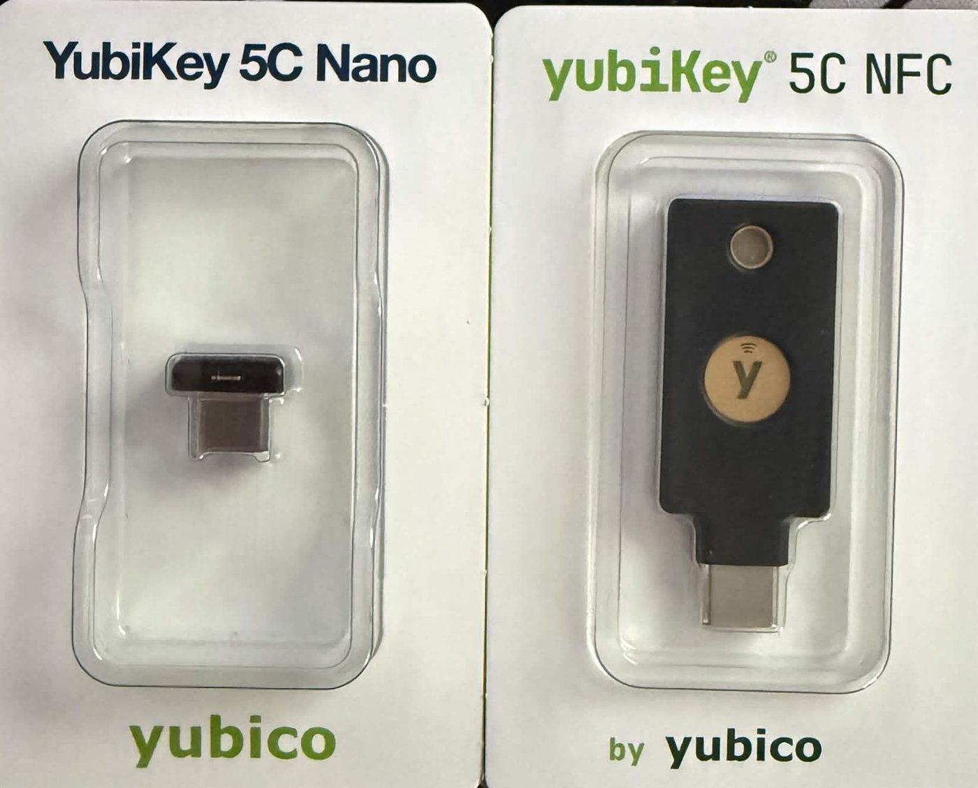 YubiKey 5C Nano and 5C NFC side by side in their blister packs, showing the size difference